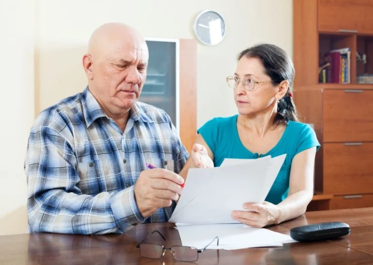 Elderly couple reviewing Medicare Advantage vs Medicare options online