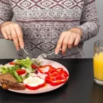 Breakfast plate with knife and fork for one meal a day diet.